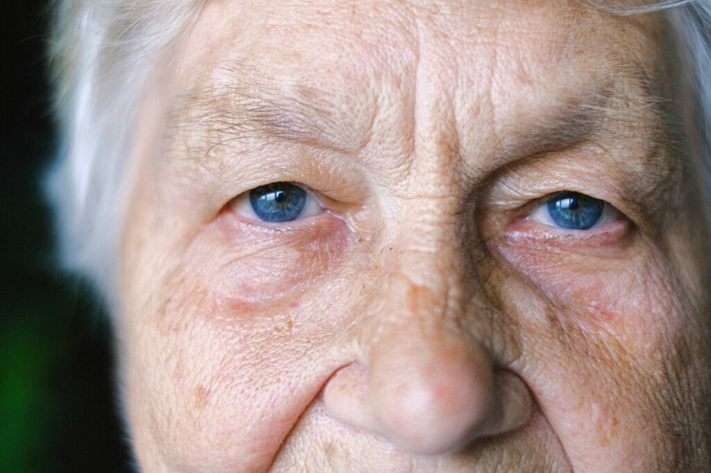 crop elderly woman with blue eyes